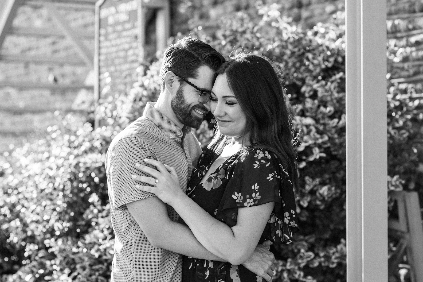 Black and white image of a couple embracing and smiling.