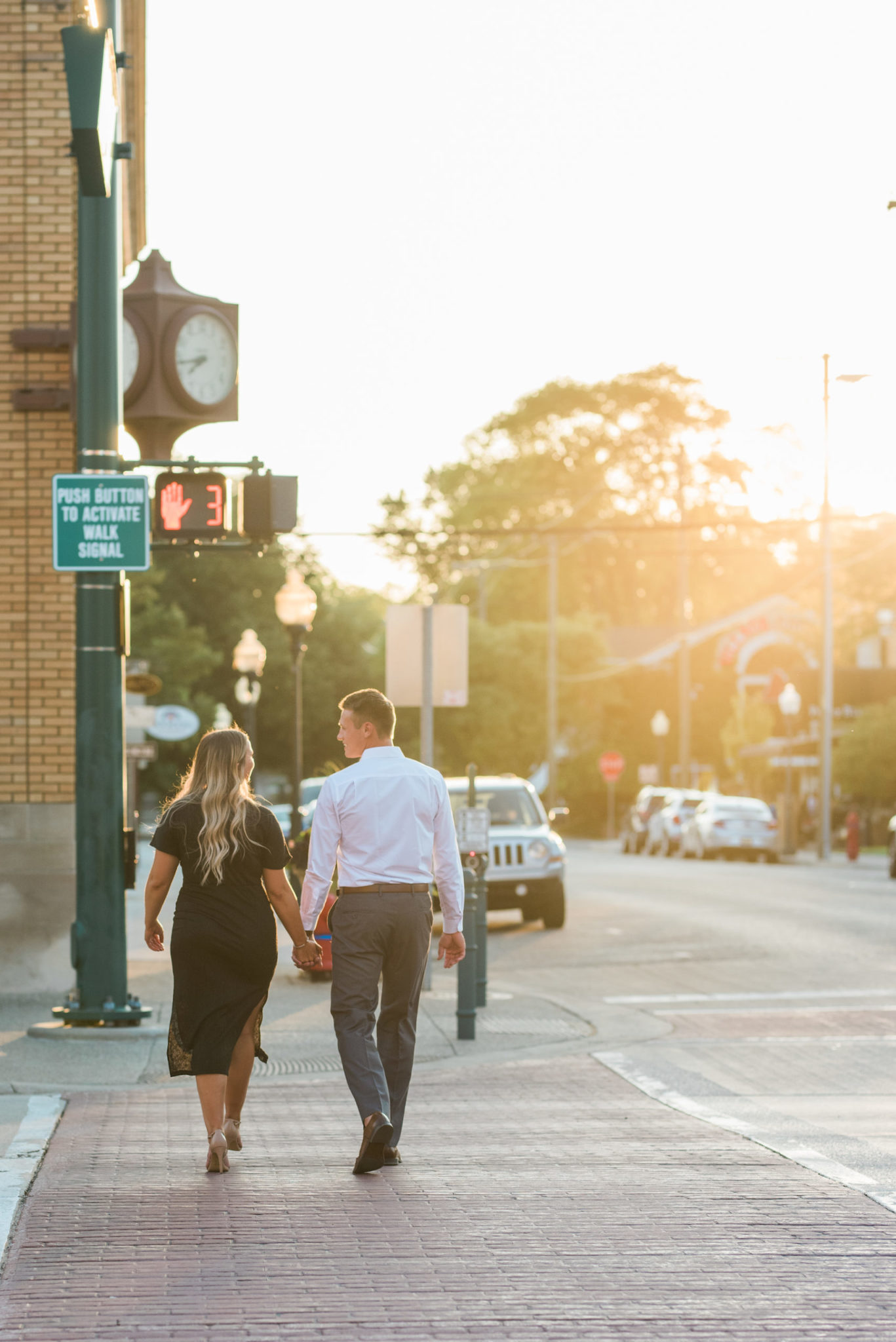 A couple walking during golden hour downtown Rochester, MI.