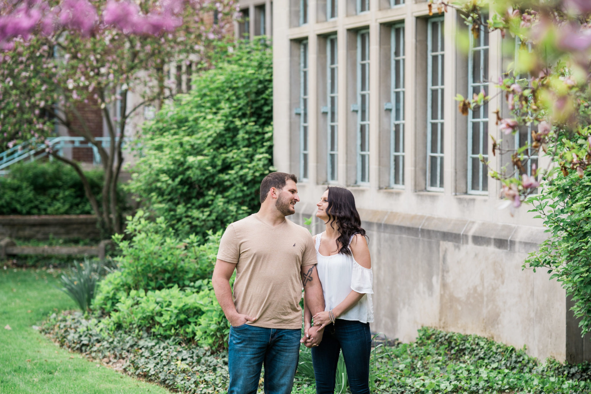 a couple looking and smiling at one another during their east lansing engagement photo session