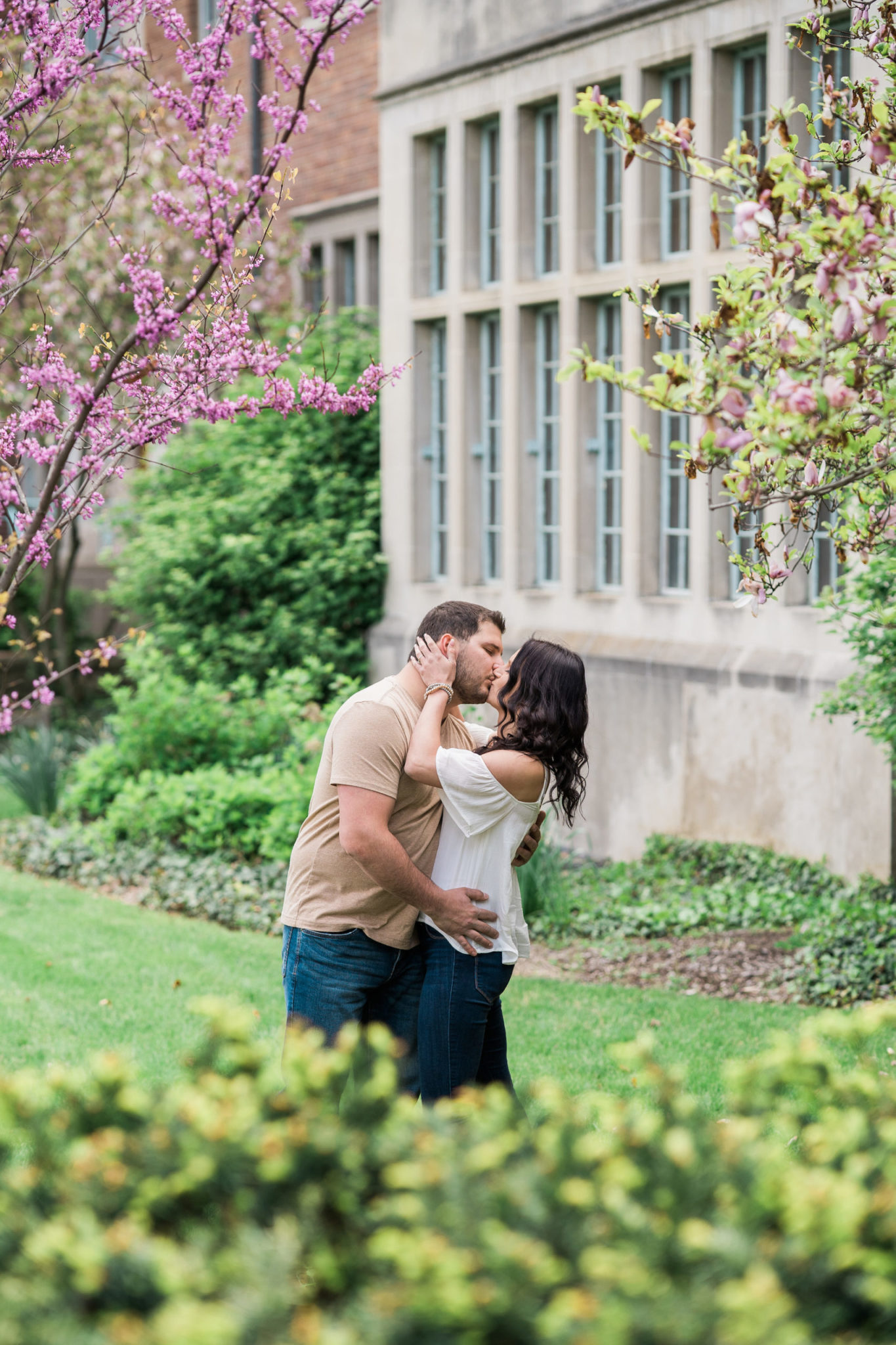 a couple kissing during their engagement photo session in east lansing