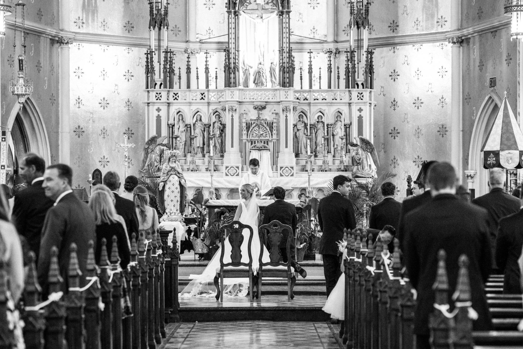 a bride and groom during their wedding ceremony at the basilica of sainte anne de detroit