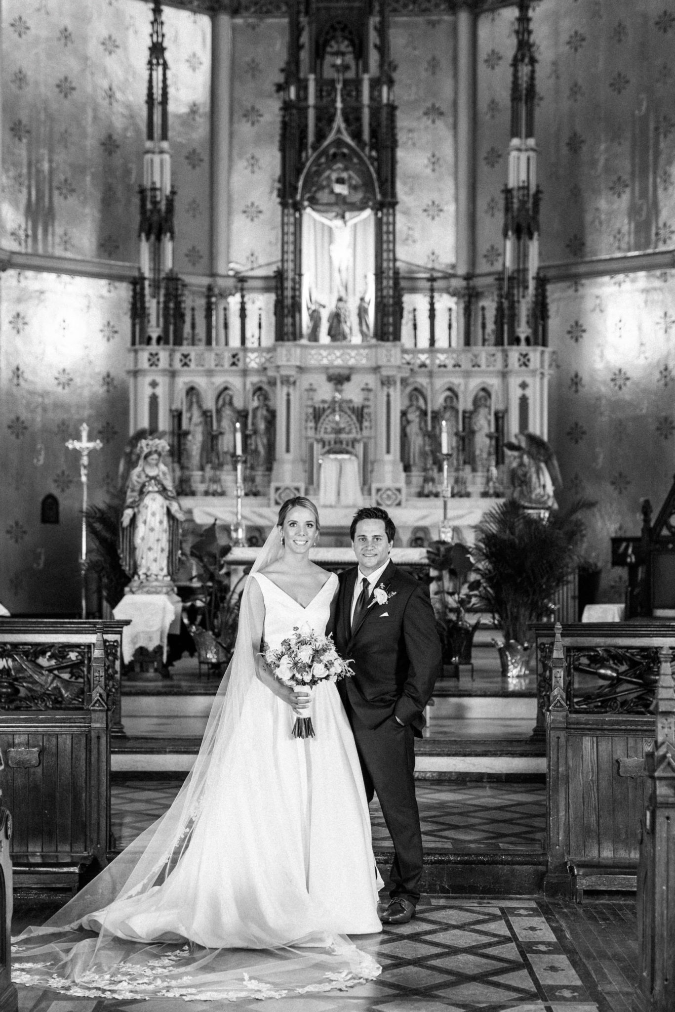 bride and groom and family portraits in the church downtown detroit after their wedding ceremony