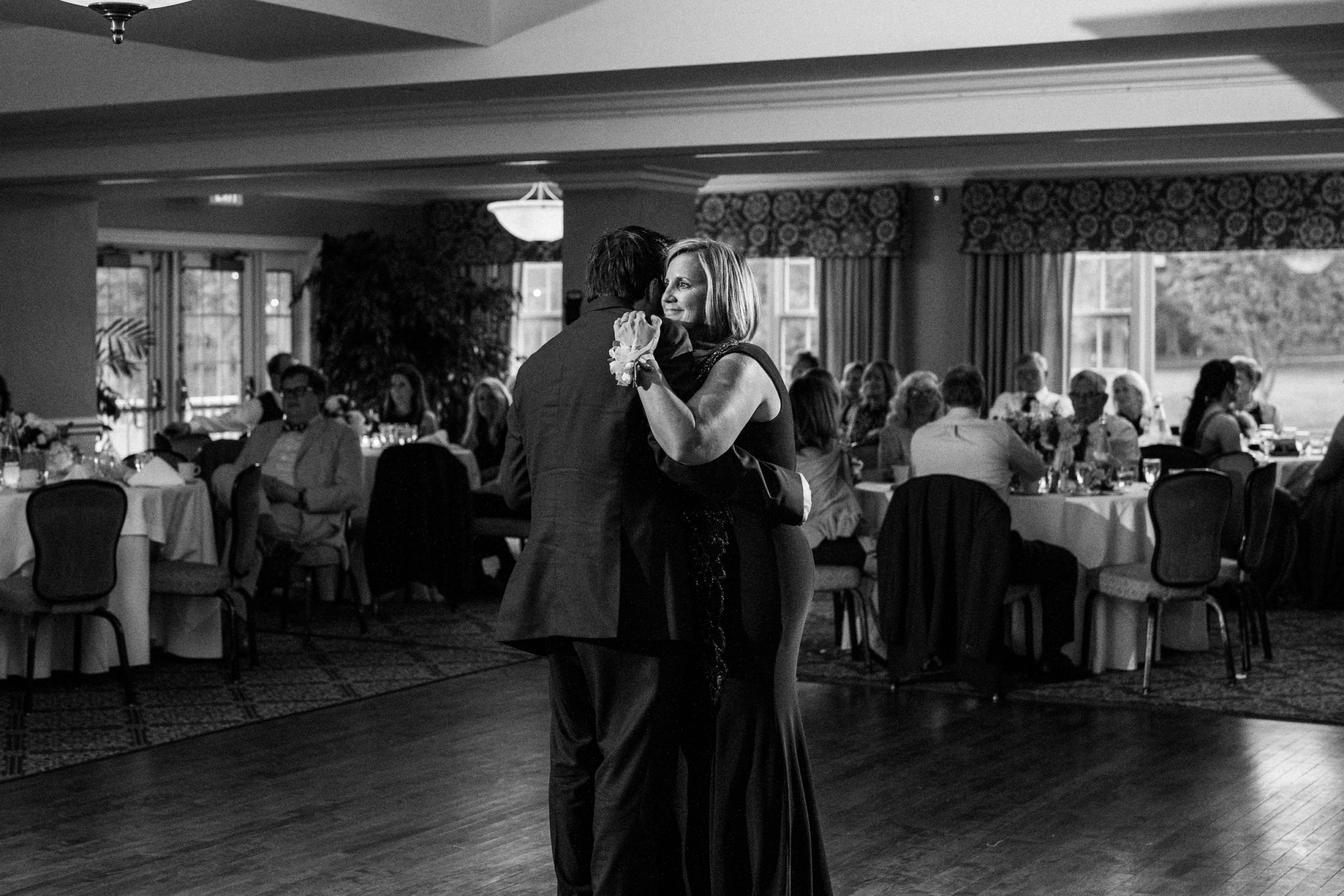 a groom dancing with his mom at a wedding at red run golf course in royal oak michigan