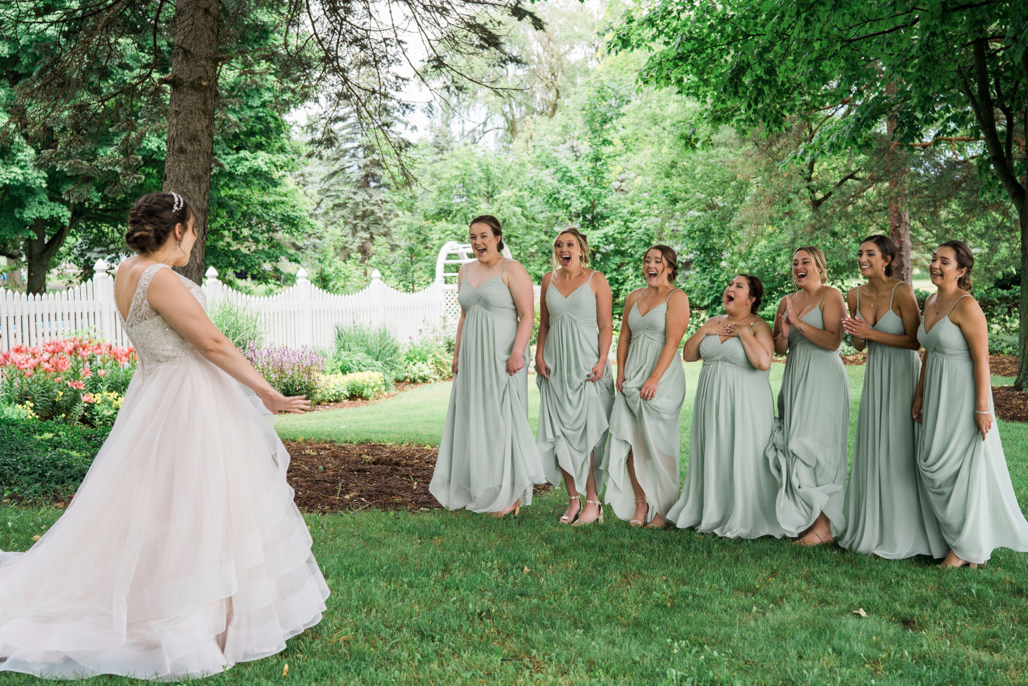 bride first look with her bridesmaids reaction on her summer wedding day