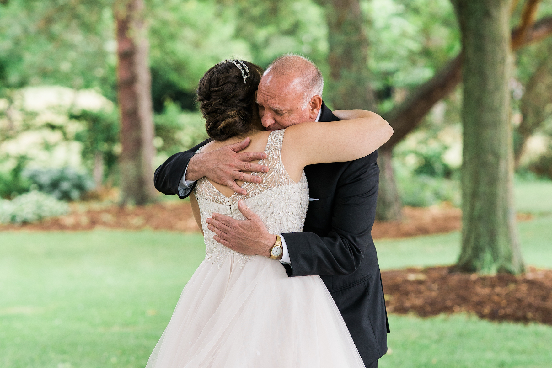 father of the bride hugging the bride on her summer wedding day