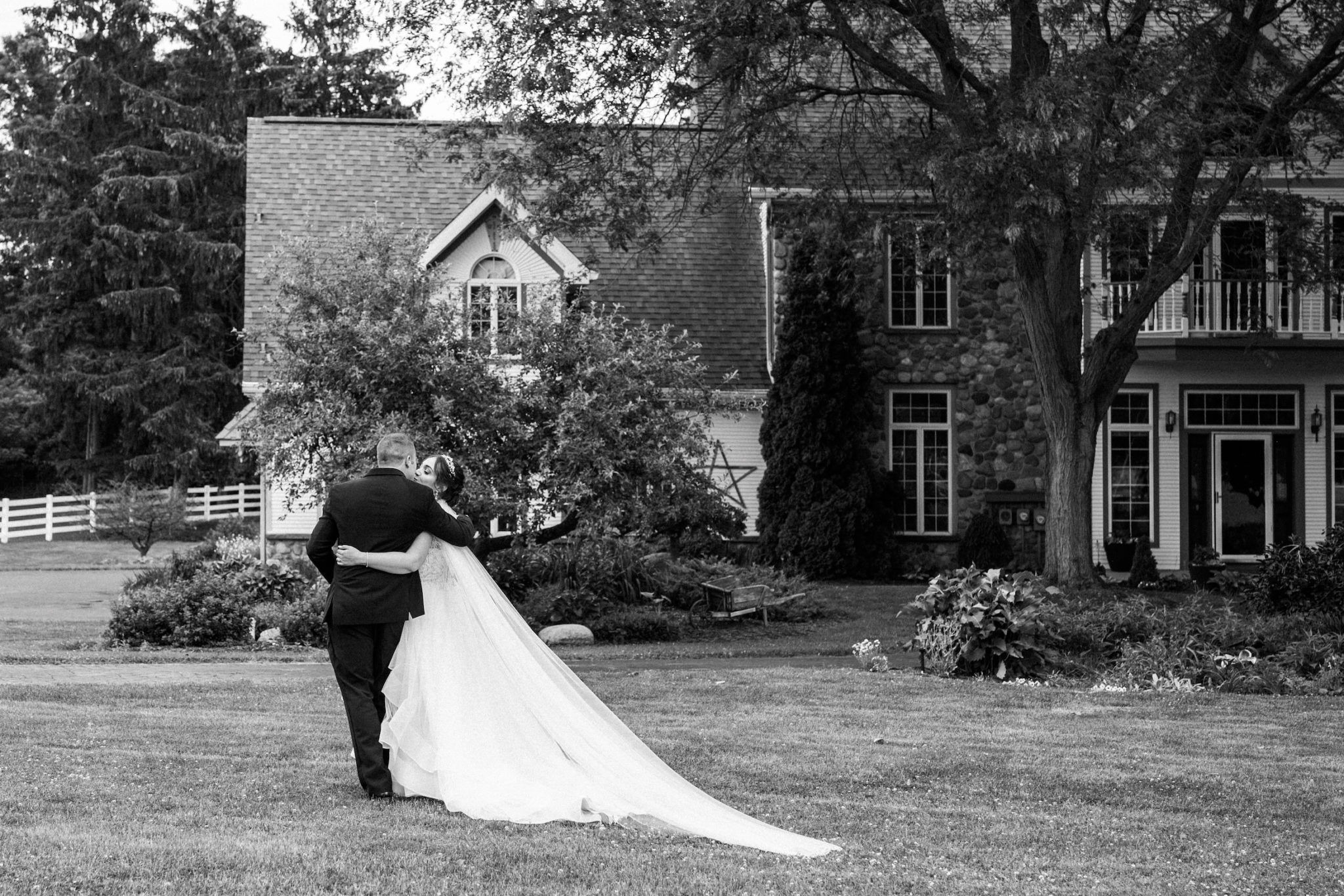 a bride and groom kissing and walking away after their wedding recessional
