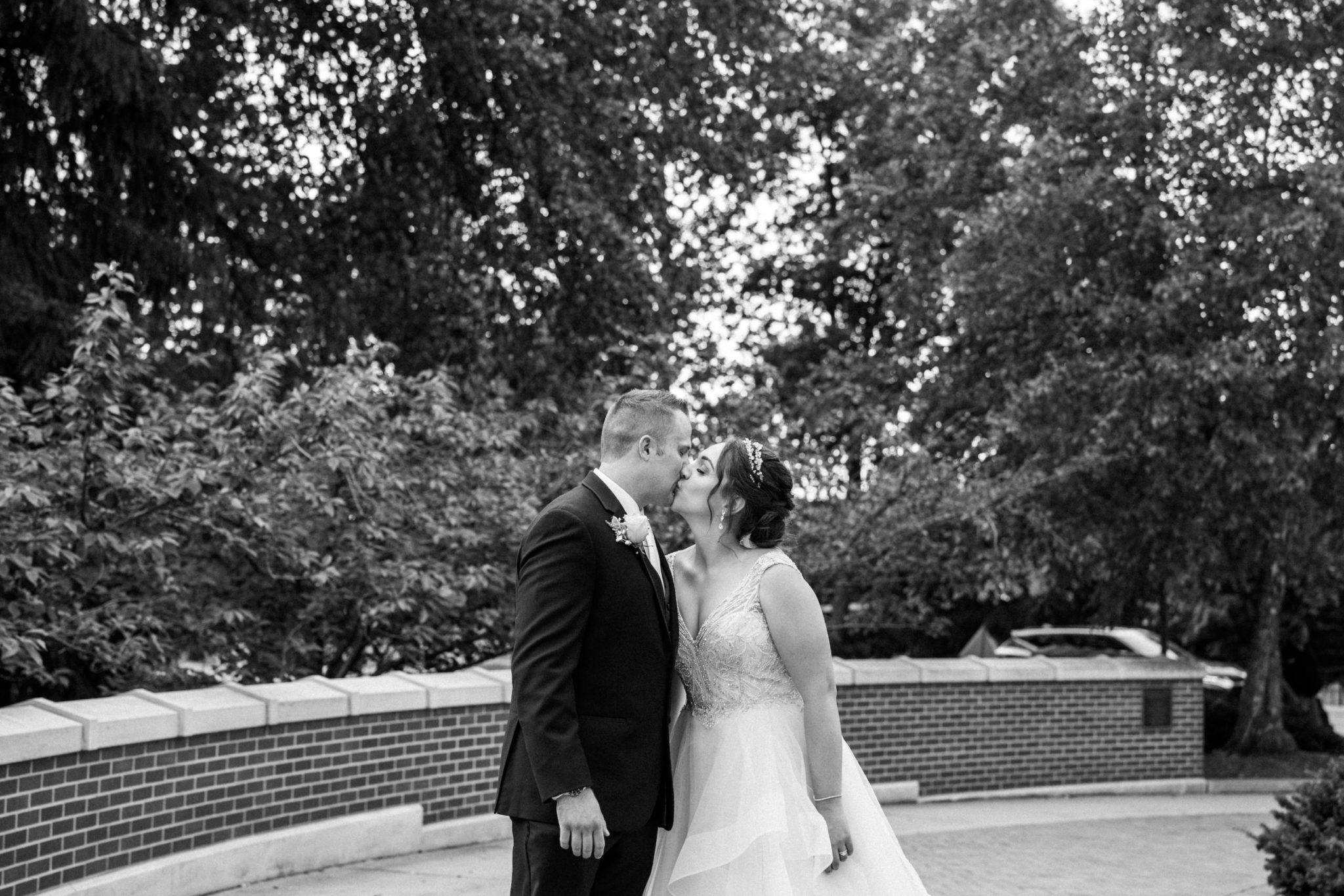 bride and groom kissing on michigan state university campus