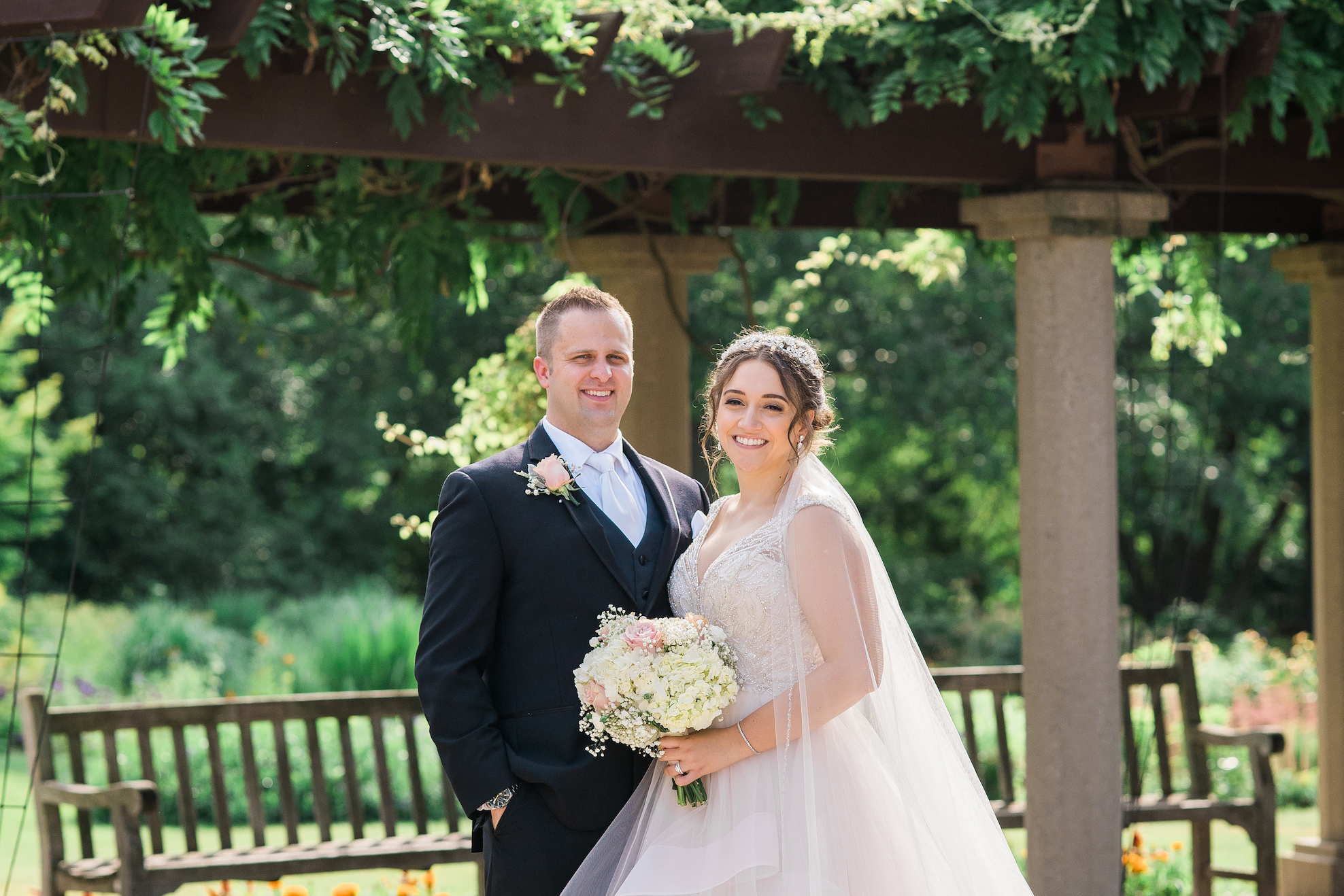 a bride and groom smiling on msu campus in east lansing michigan