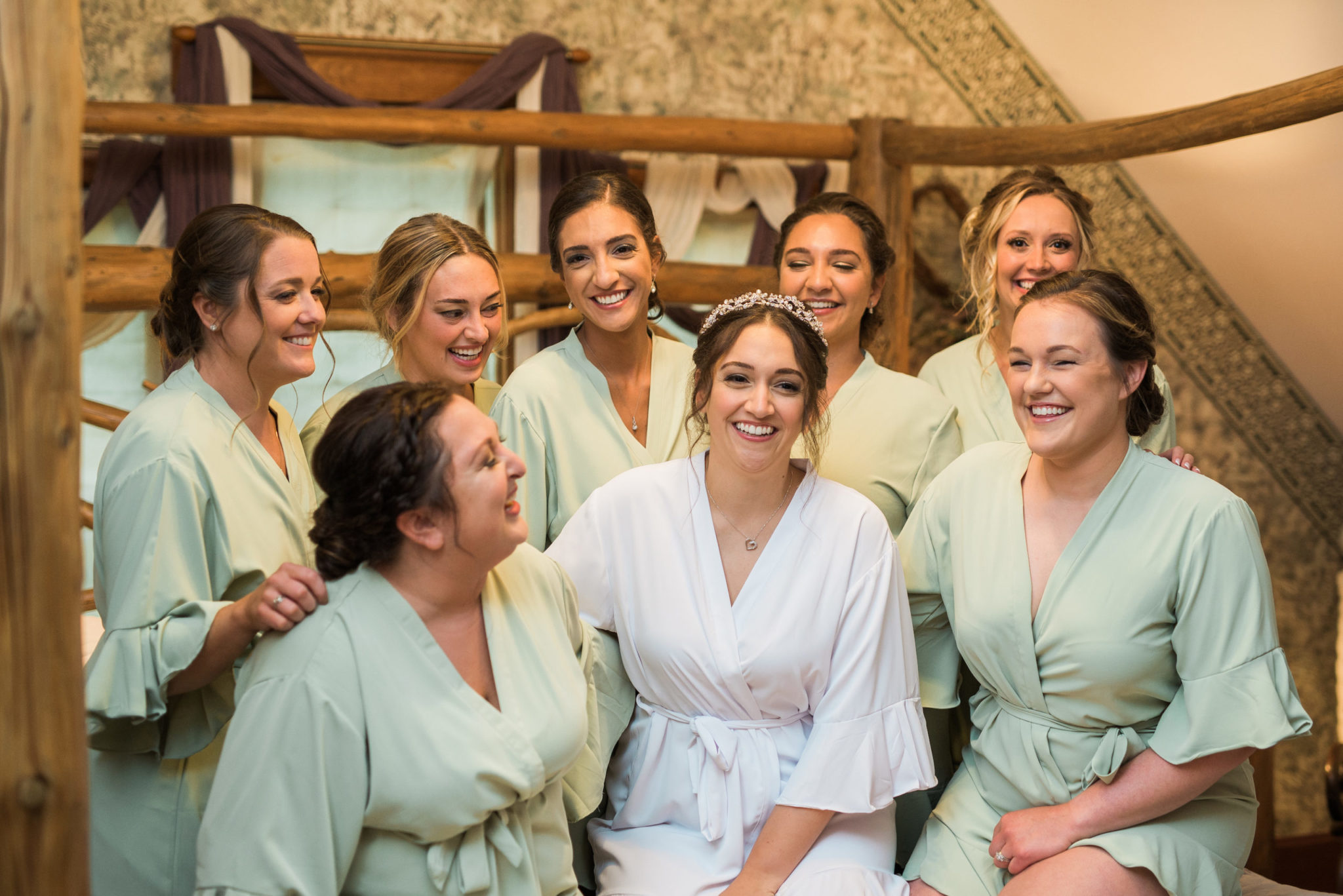 a bride smiling with her bridesmaids during getting ready photos