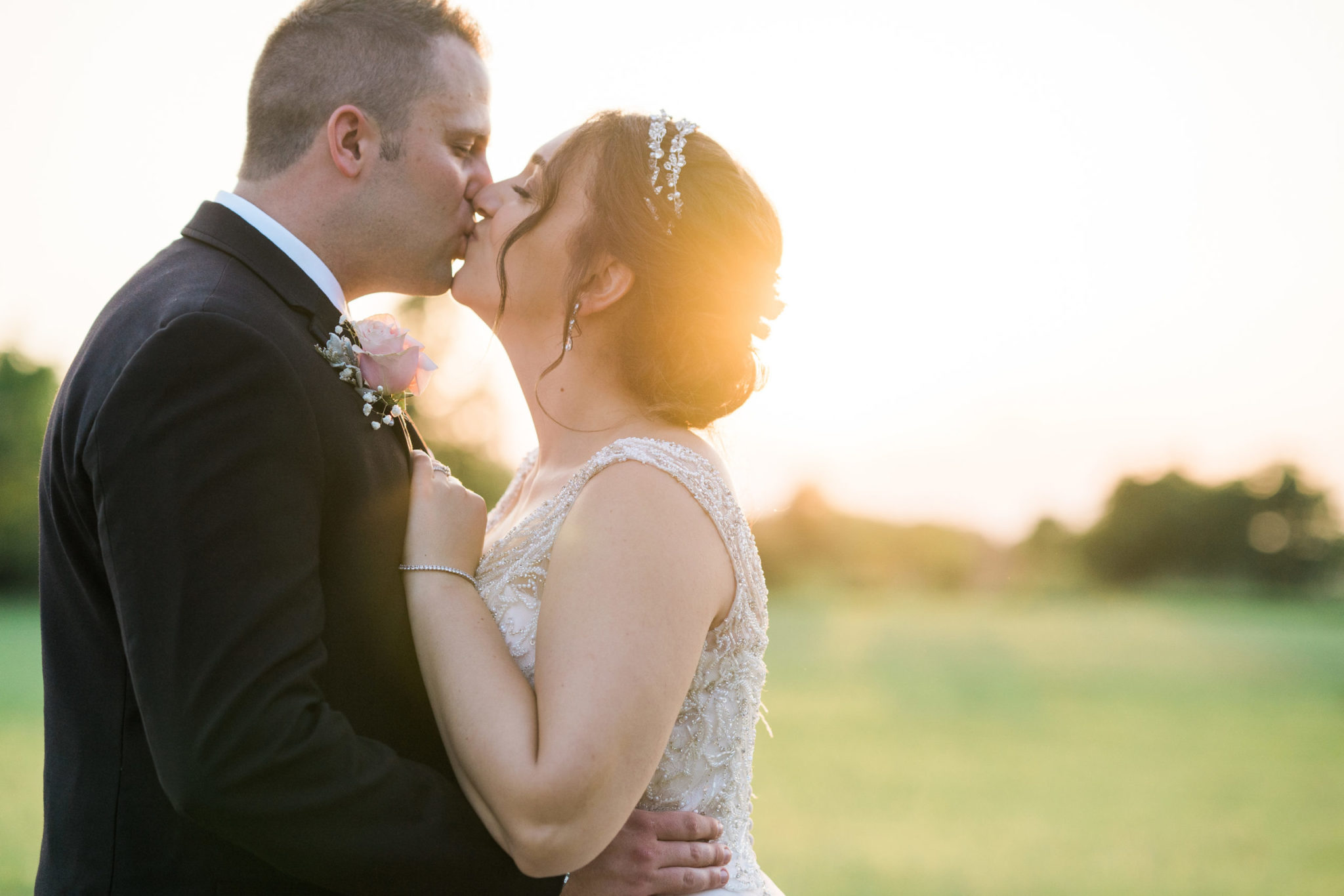 bride and groom kissing during golden hour pictures