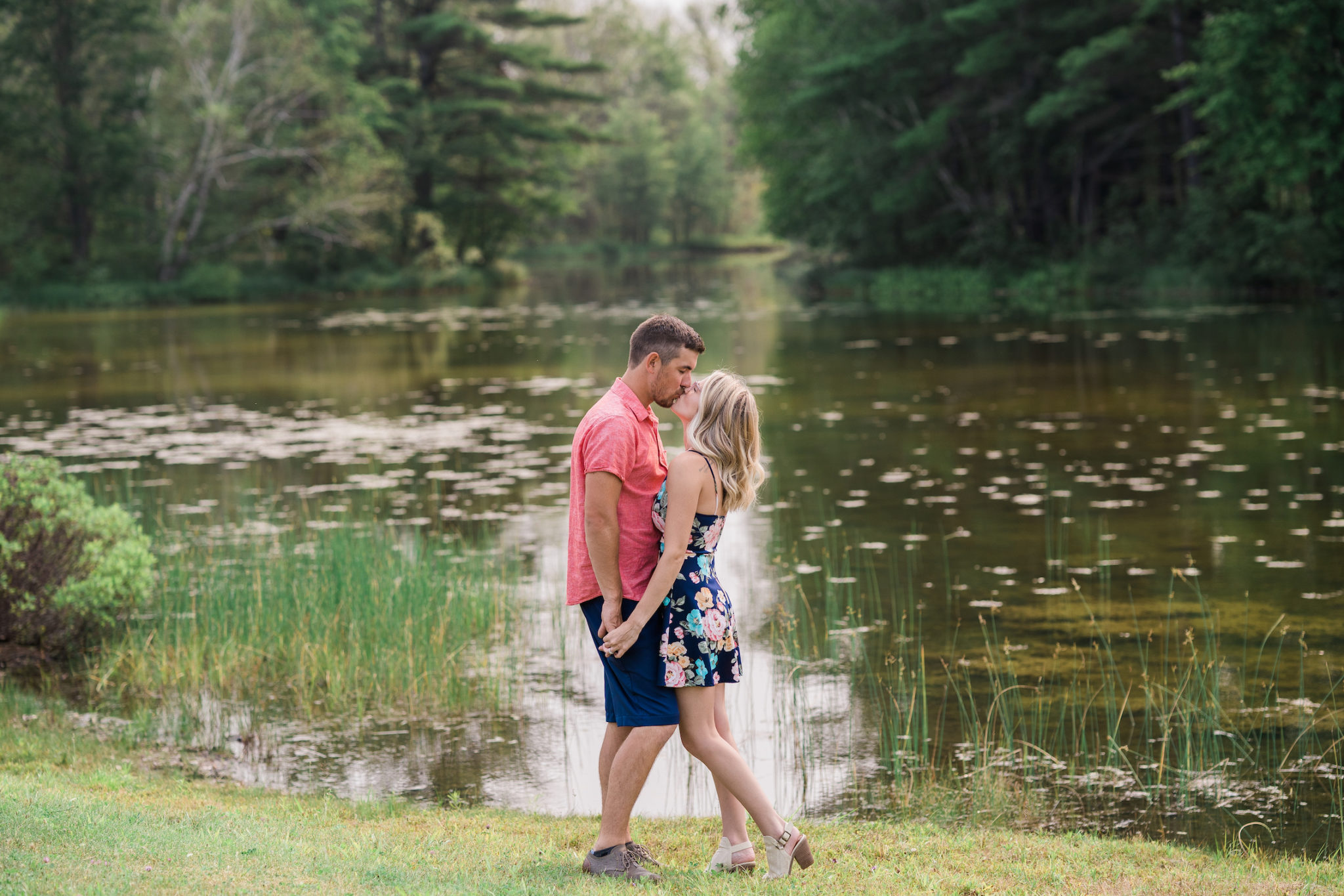 a couple kissing during their engagement photo session in northern michigan