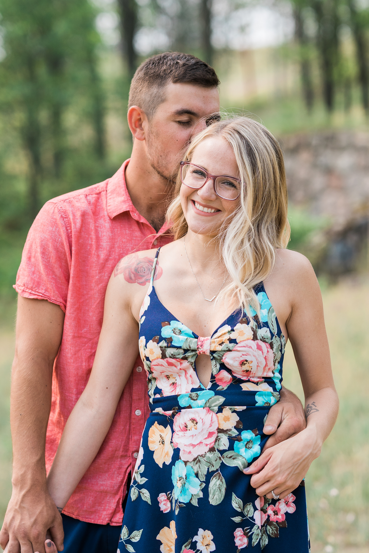 a couple embracing and smiling during their engagement photos in grayling michigan
