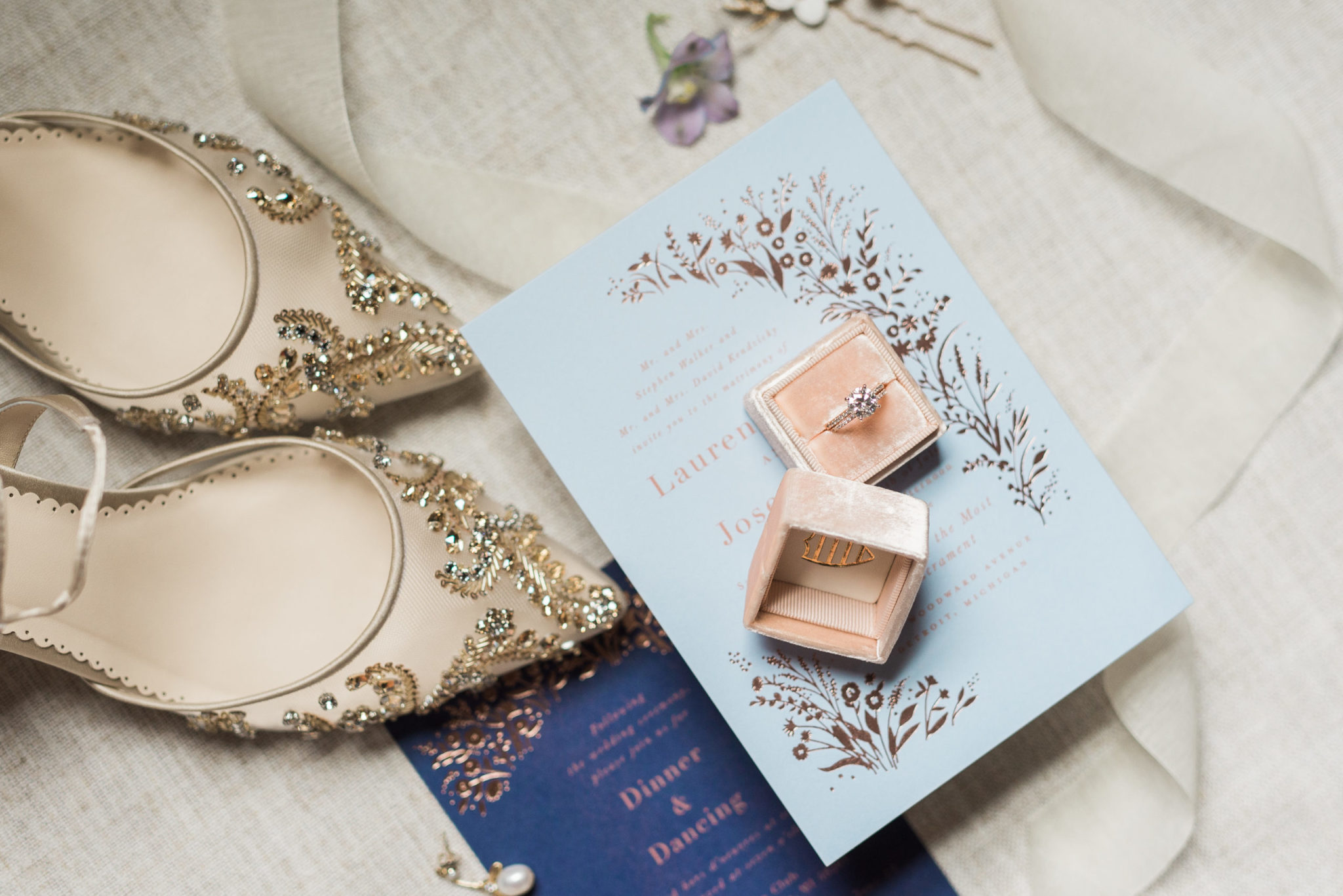 wedding day details including shoes, ring, and stationary wedding invitations