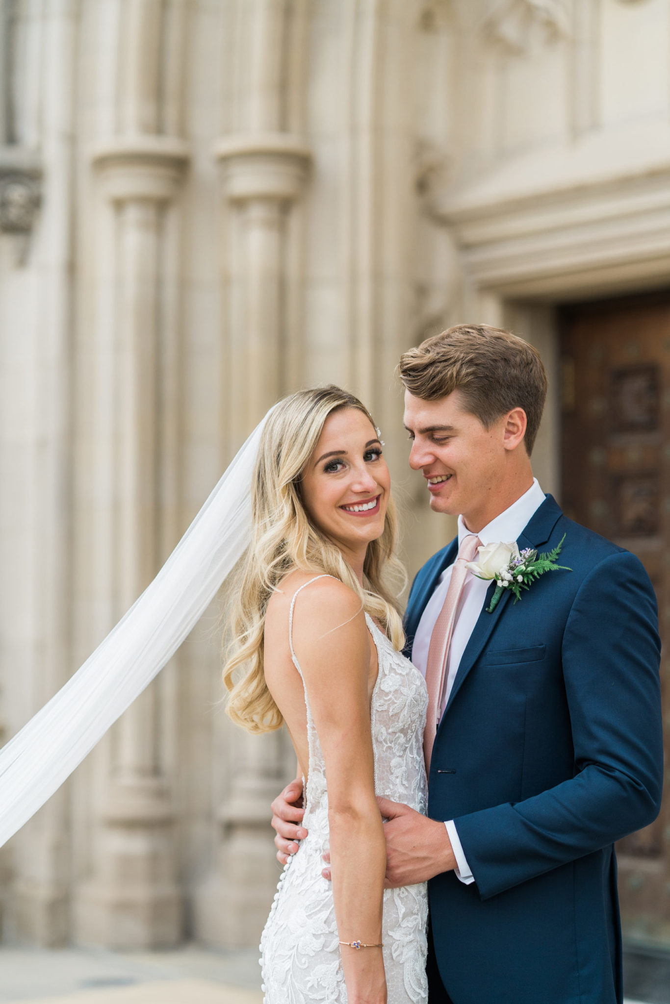a classic bride and groom wedding portrait in front of the church