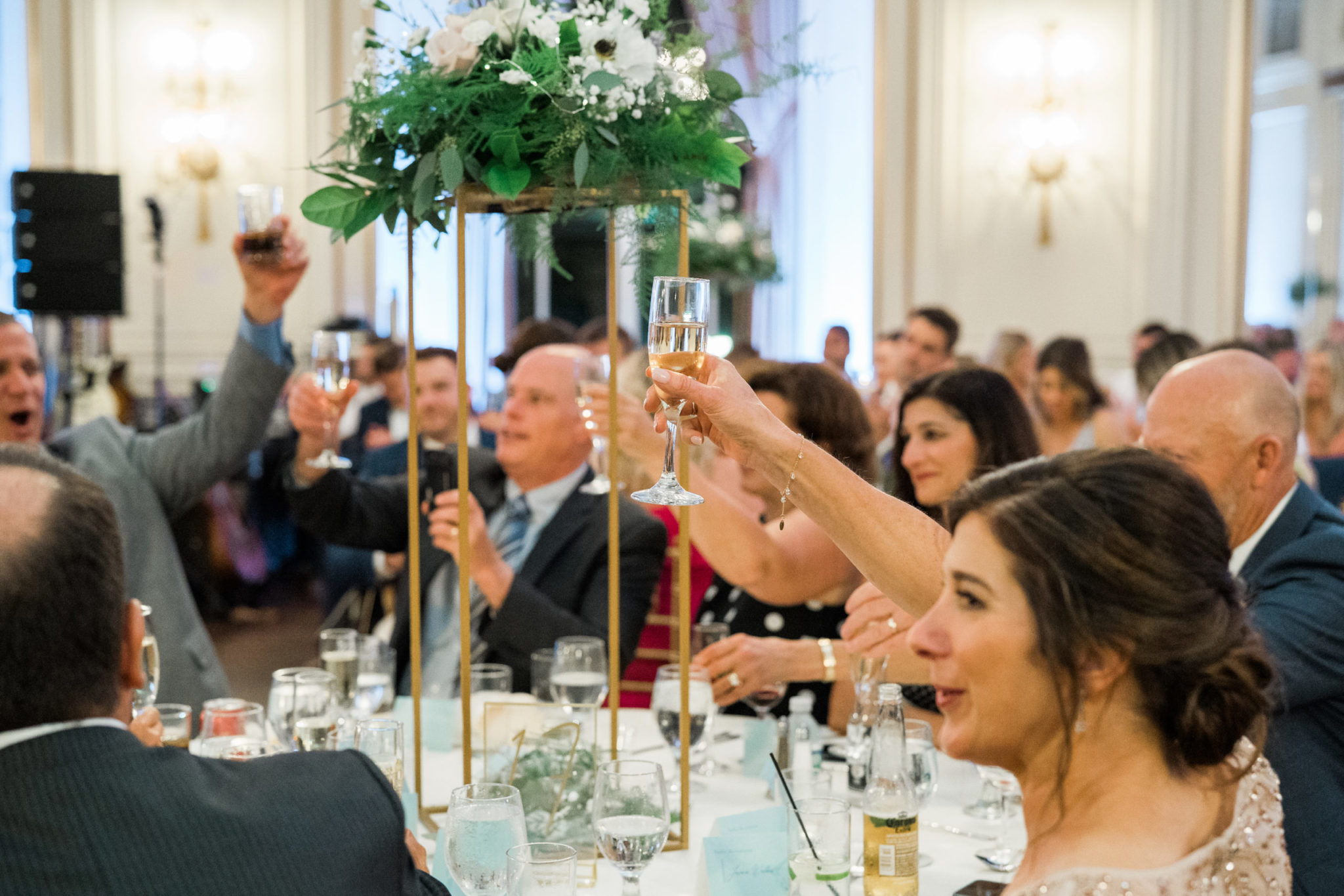 a glass of champagne toast during a colony club wedding reception